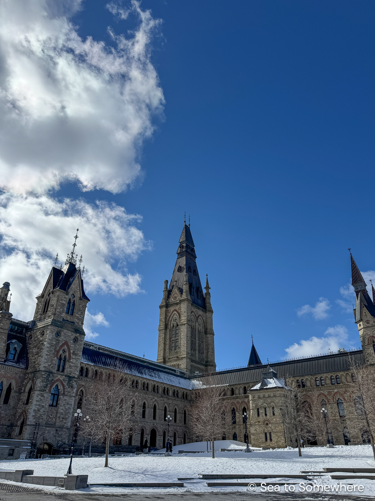 Parliament buildings in Ottawa in March with a bright blue sky behind.